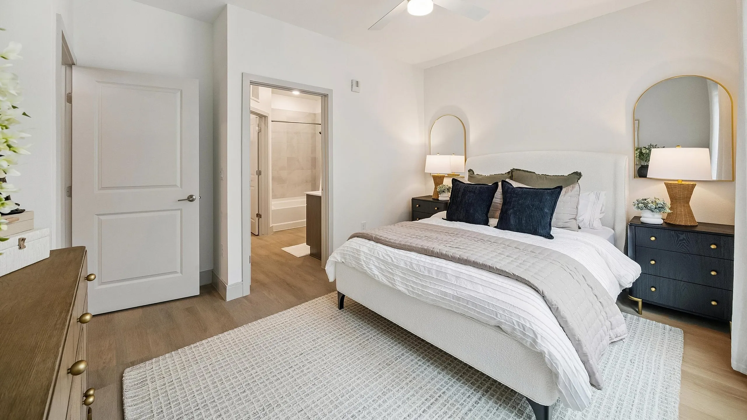 Elegant and cozy bedroom with modern furnishings, soft lighting, and a serene ambiance, featuring a stylish ensuite bathroom.