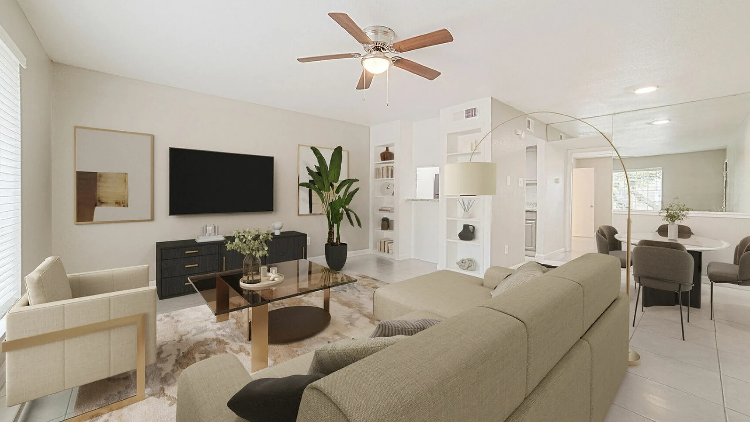 Elegant living room with stylish neutral decor, featuring a sleek TV setup, lush potted plant, and modern dining area.