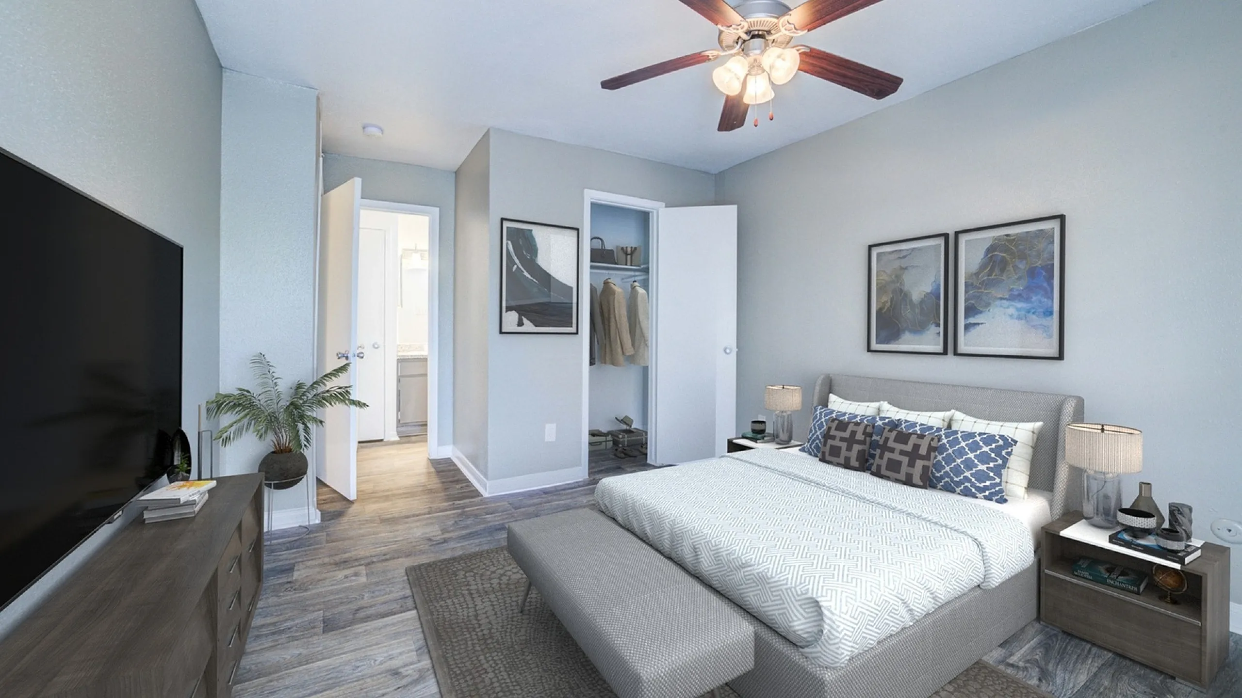 Elegant bedroom showcasing a luxurious bed with stylish cushions, modern decor, and sleek wood flooring, illuminated by a chic ceiling fan.