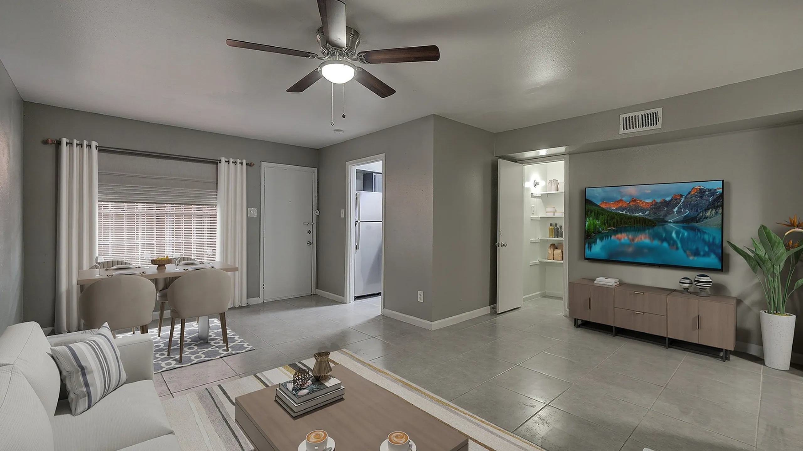 Contemporary living room with stylish decor, open dining area, and modern kitchen in a charming apartment.