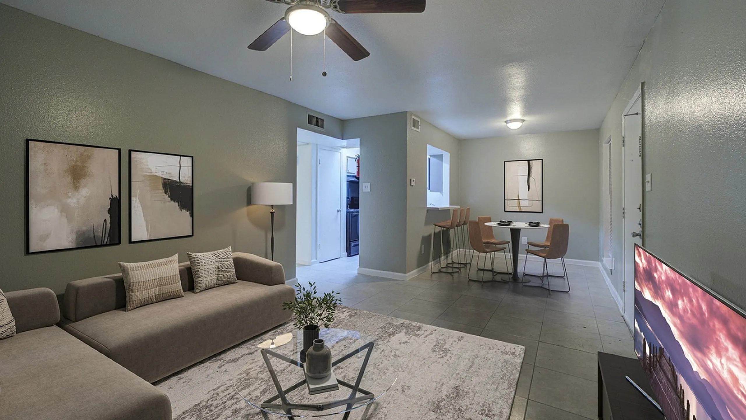 Contemporary living room with a cozy sofa, modern artwork, and a sleek dining area, perfect for stylish urban living.