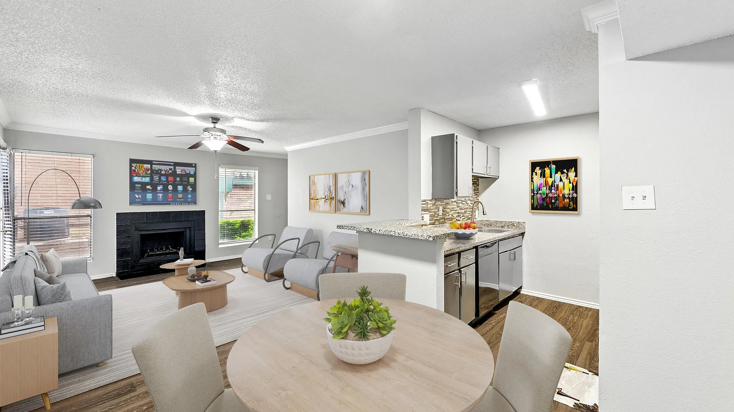 Modern living space featuring a cozy seating area, contemporary fireplace, and a stylish open kitchen with elegant finishes.