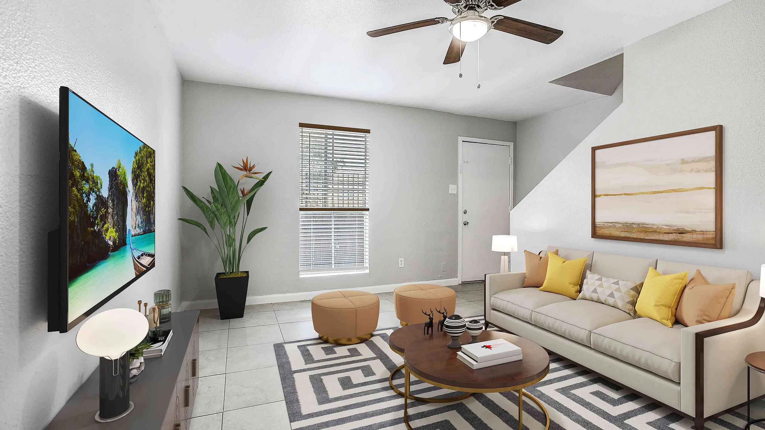 Modern living room with a stylish ceiling fan, cozy beige sofa adorned with vibrant pillows, a sleek coffee table, and a flat-screen TV on a minimalist console.