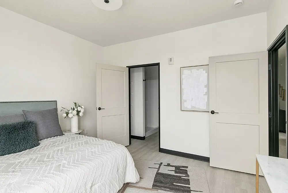 Bright and airy bedroom featuring elegant decor, soft bedding, and minimalist style for ultimate comfort.