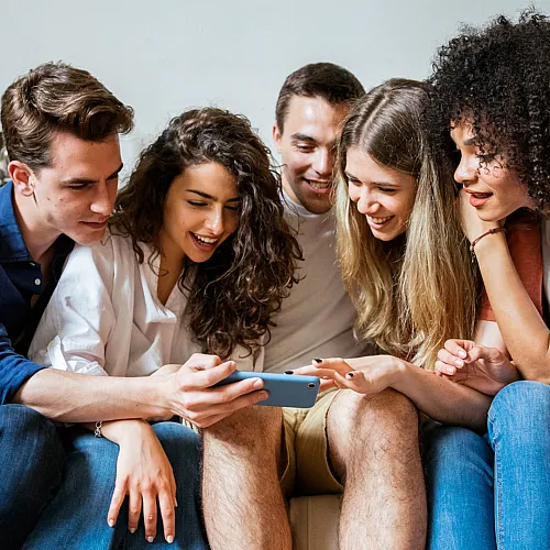 Group of Friends Looking at Phone Together