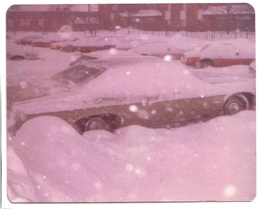 Nostalgic winter scene of a snow-covered parking lot with buried cars, capturing a serene and quiet beauty.