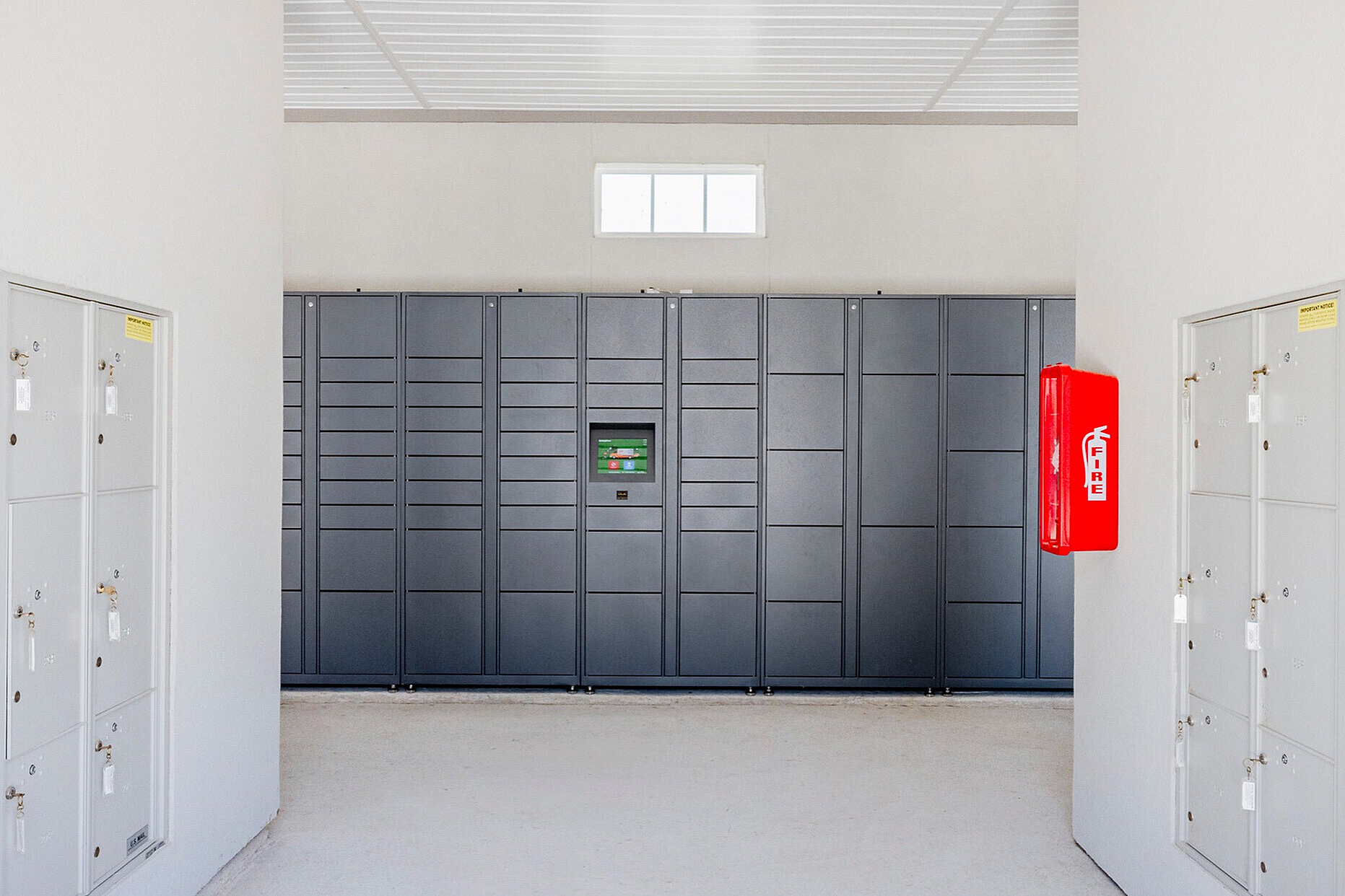 Modern package locker room with sleek grey lockers and secure storage solutions.