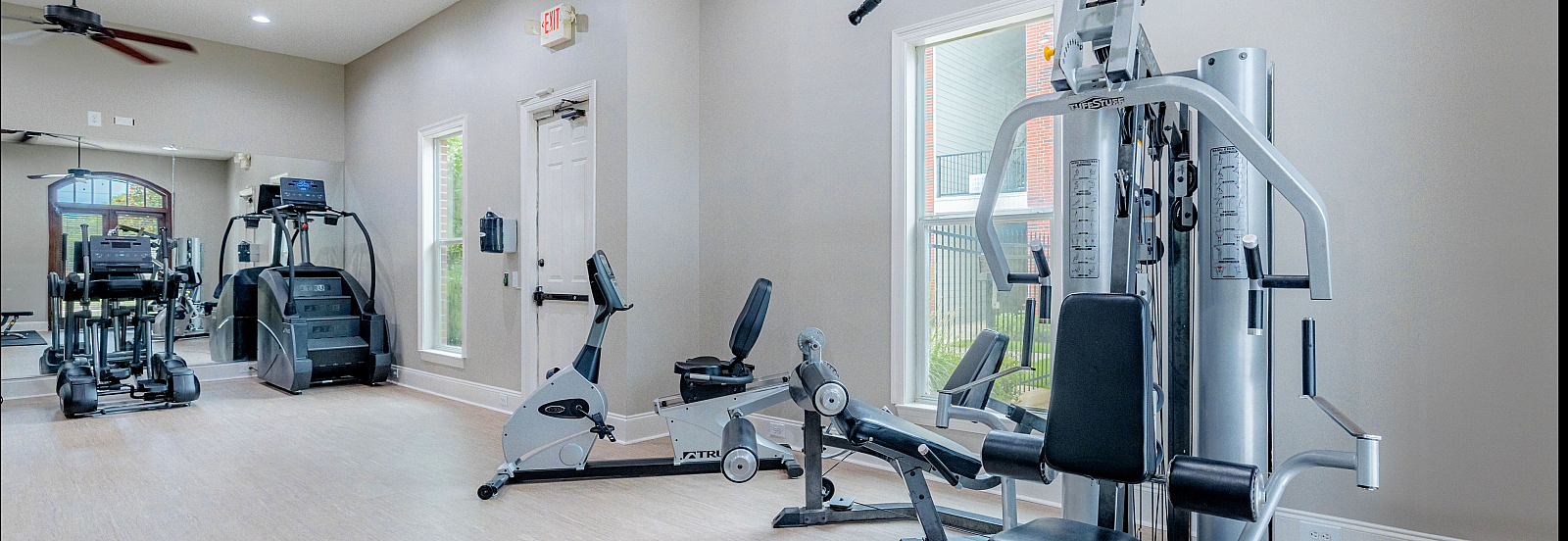 Modern fitness center with high-end workout equipment and natural lighting.