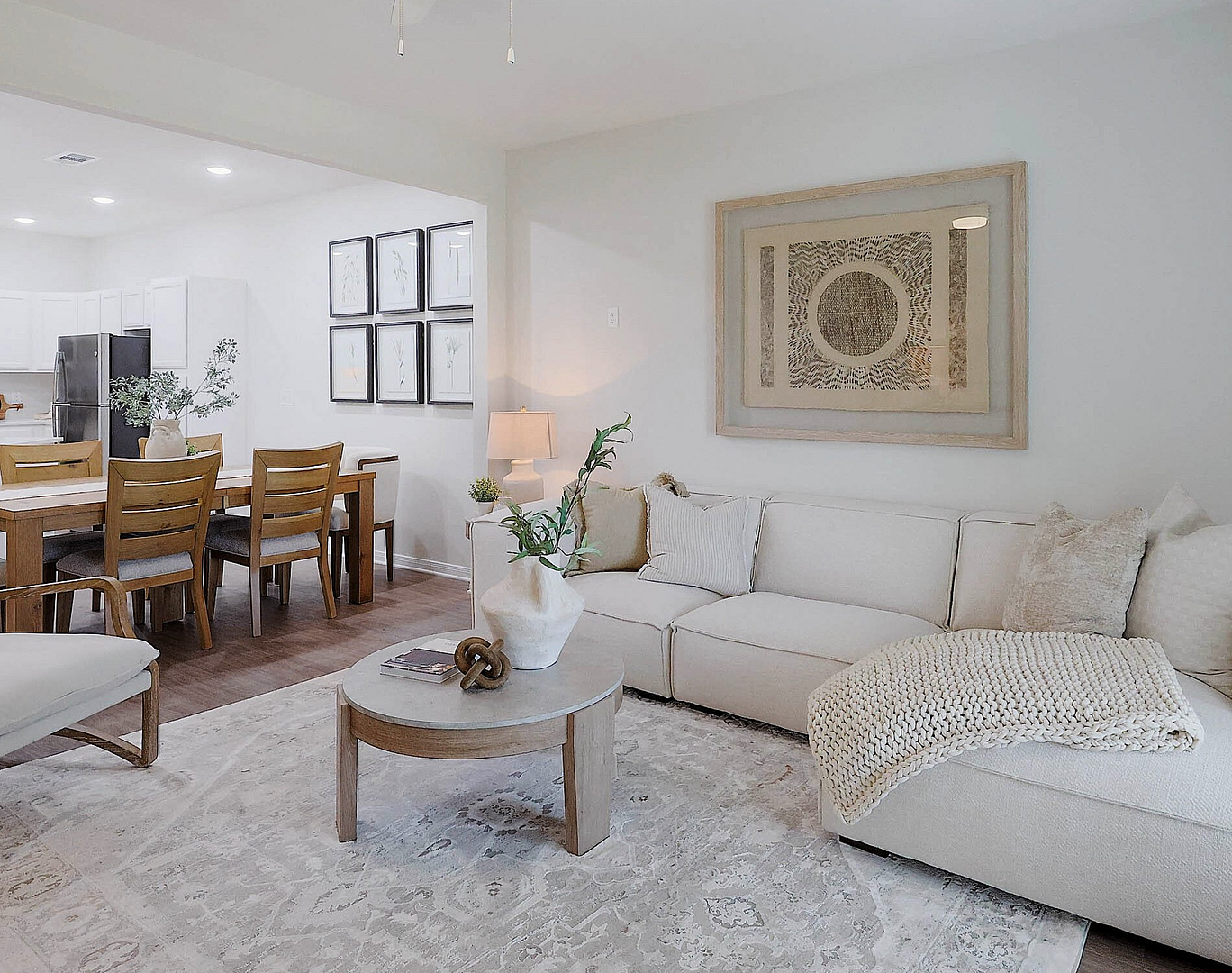 Bright and inviting living space with a cozy sectional, elegant decor, and open dining area.