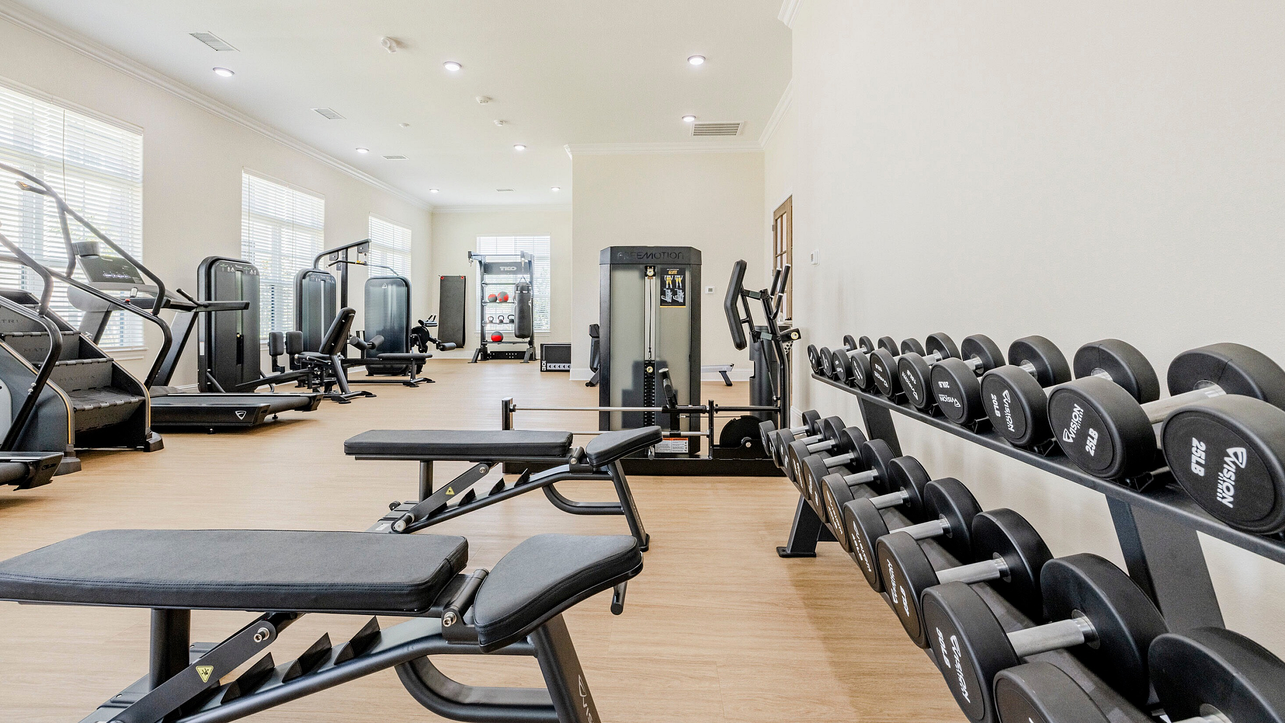 Bright, modern fitness center equipped with state-of-the-art machines and free weights, offering a perfect place for invigorating workouts.
