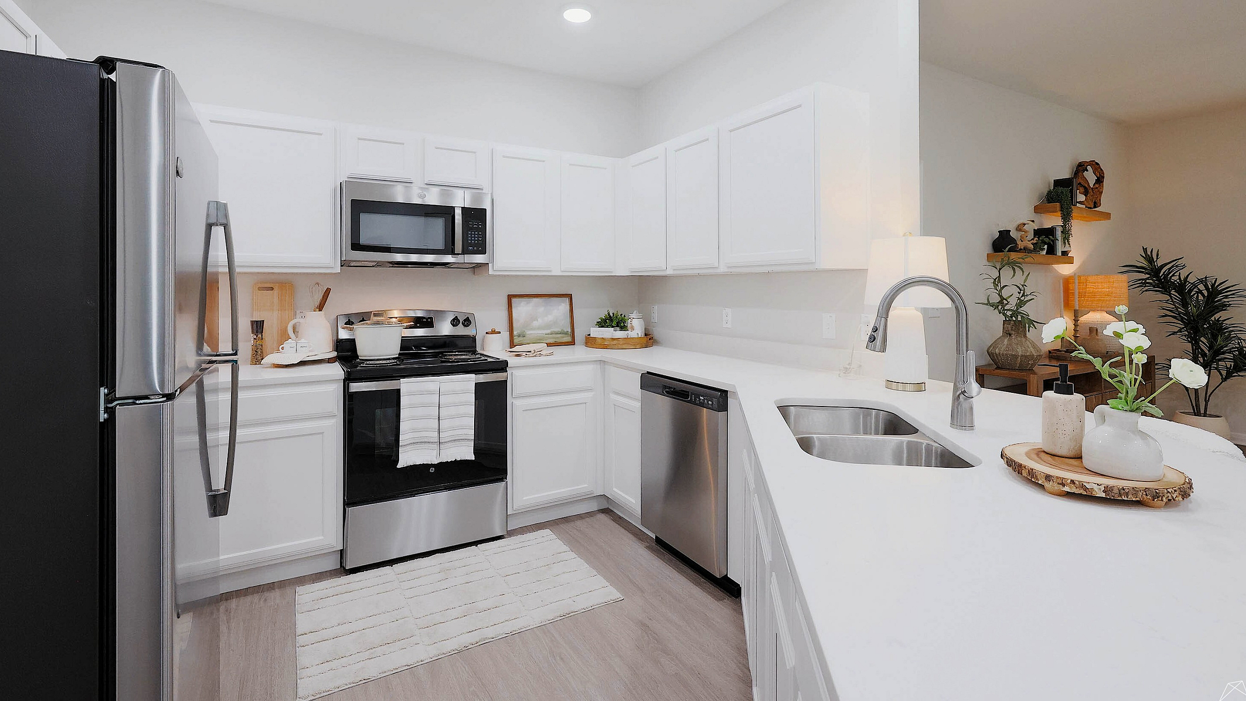 Modern kitchen with sleek stainless steel appliances, elegant white cabinetry, and a stylish open layout.
