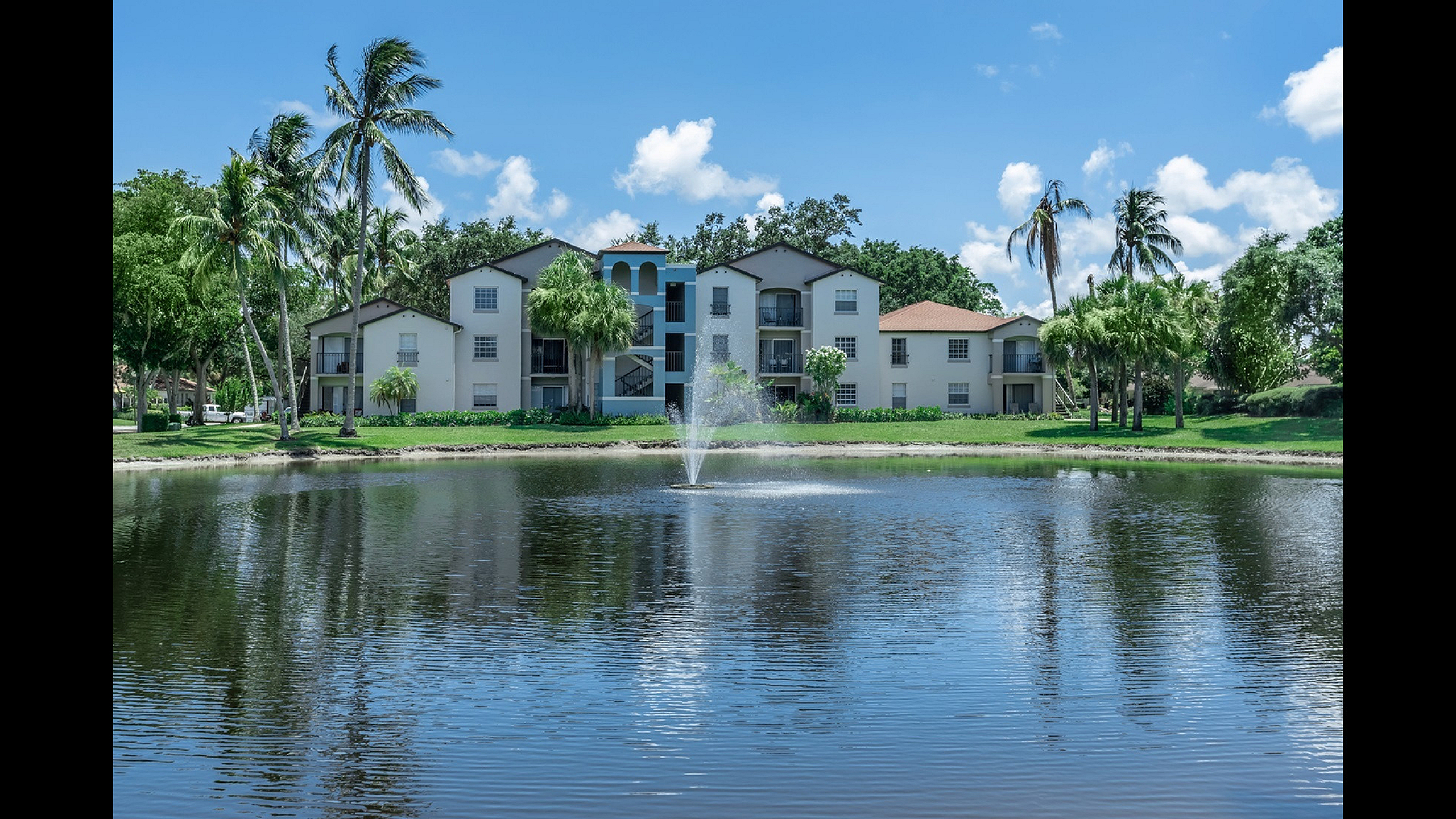Latitude Pointe Apartments Building Exterior with Pond and Fountain