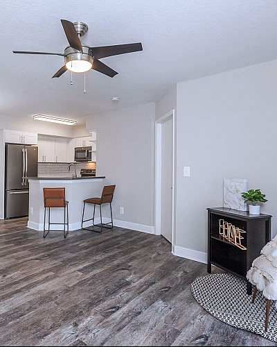 Latitude Pointe Apartments Interior Kitchen with White Shaker Cabinets, Stainless Steel Appliances and Wood-Style Plank Floors