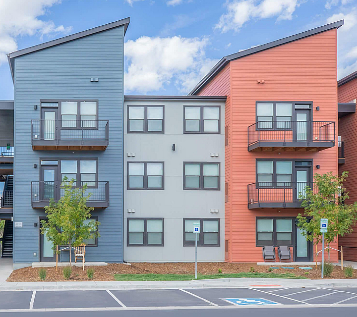 The Depot at Twenty Mile Apartments Building Exterior Blue, Red and Gray Siding with Balconies and Patios