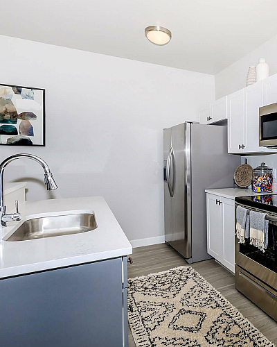 The Depot Station Interior with White Shaker Cabinetry, Stainless Steel Appliances and Quartz Countertops