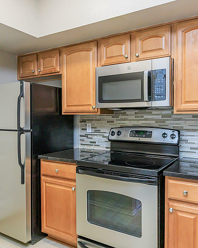 The Jefferson at Fair Oaks Modern Kitchen with Oak Cabinets and Stainless Steel Appliances