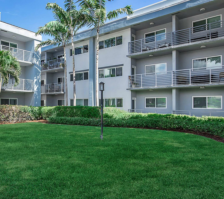2500 Boca on Federal Apartments Building Exterior with Lush Landscaping, Blue and White Modern Building Facade