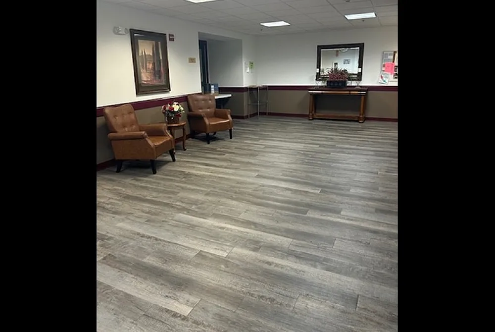 Elegant lobby area with stylish wood flooring, comfortable leather seating, and tasteful decor, creating a welcoming and luxurious ambiance.