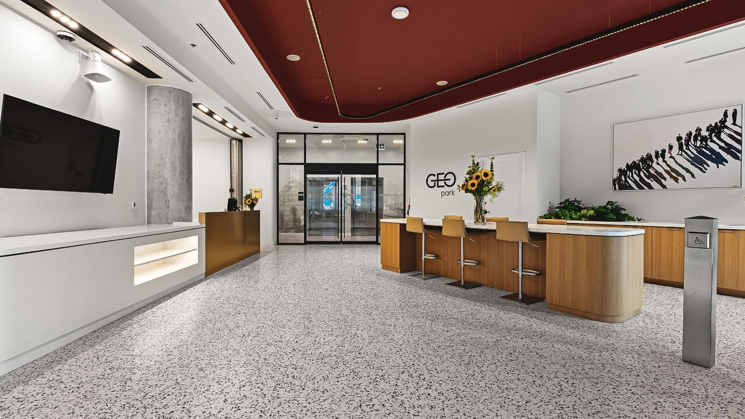 Sleek and modern lobby featuring stylish seating, vibrant artwork, and elegant design accents at Geo Park.