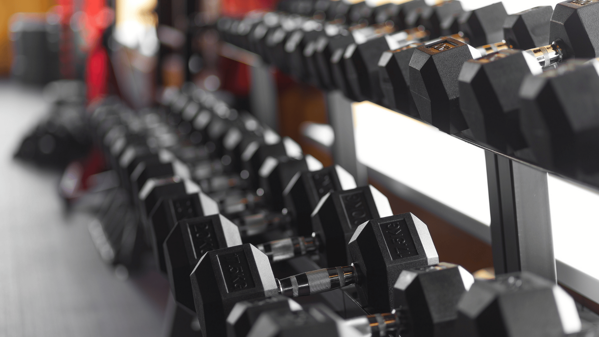 stock photo of dumbell weights on a rack