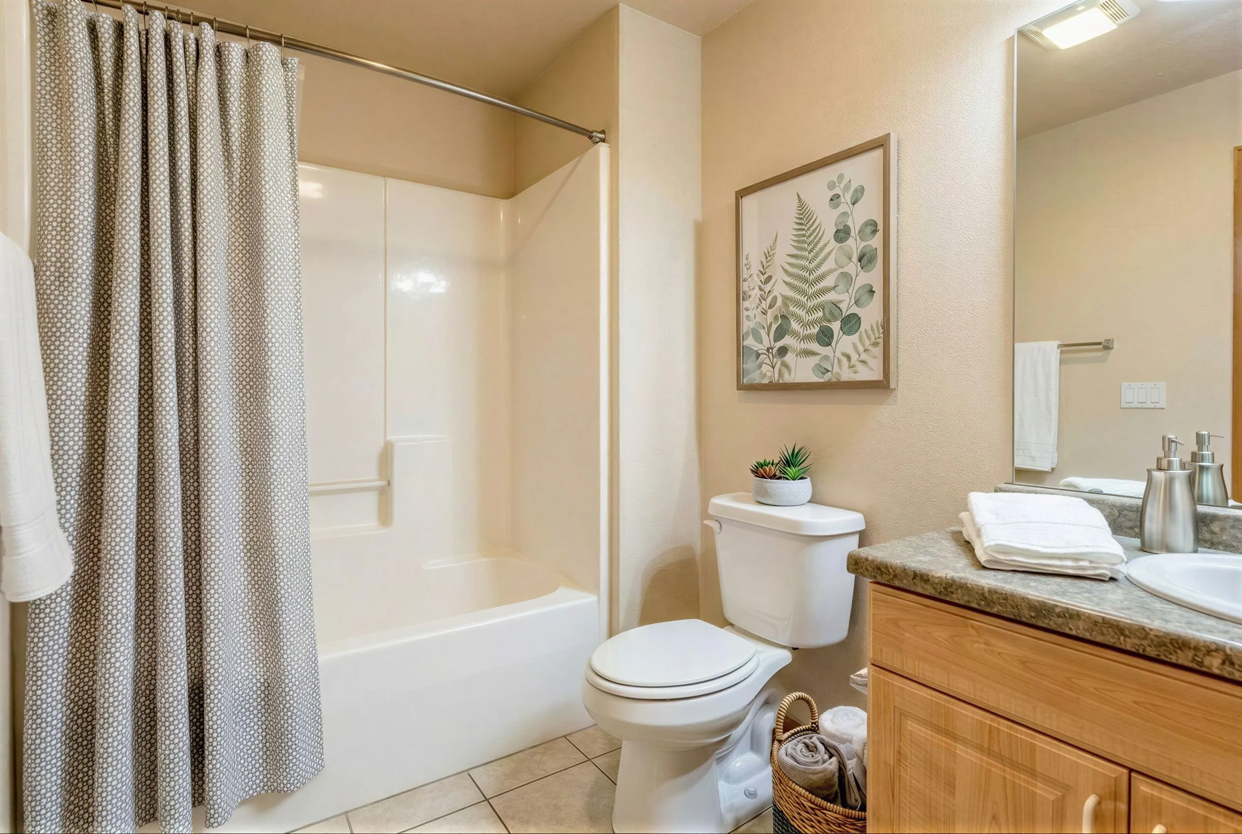 Inviting bathroom featuring a stylish shower curtain, elegant tile flooring, and a charming fern artwork. Includes a sleek countertop with modern stainless fixtures.