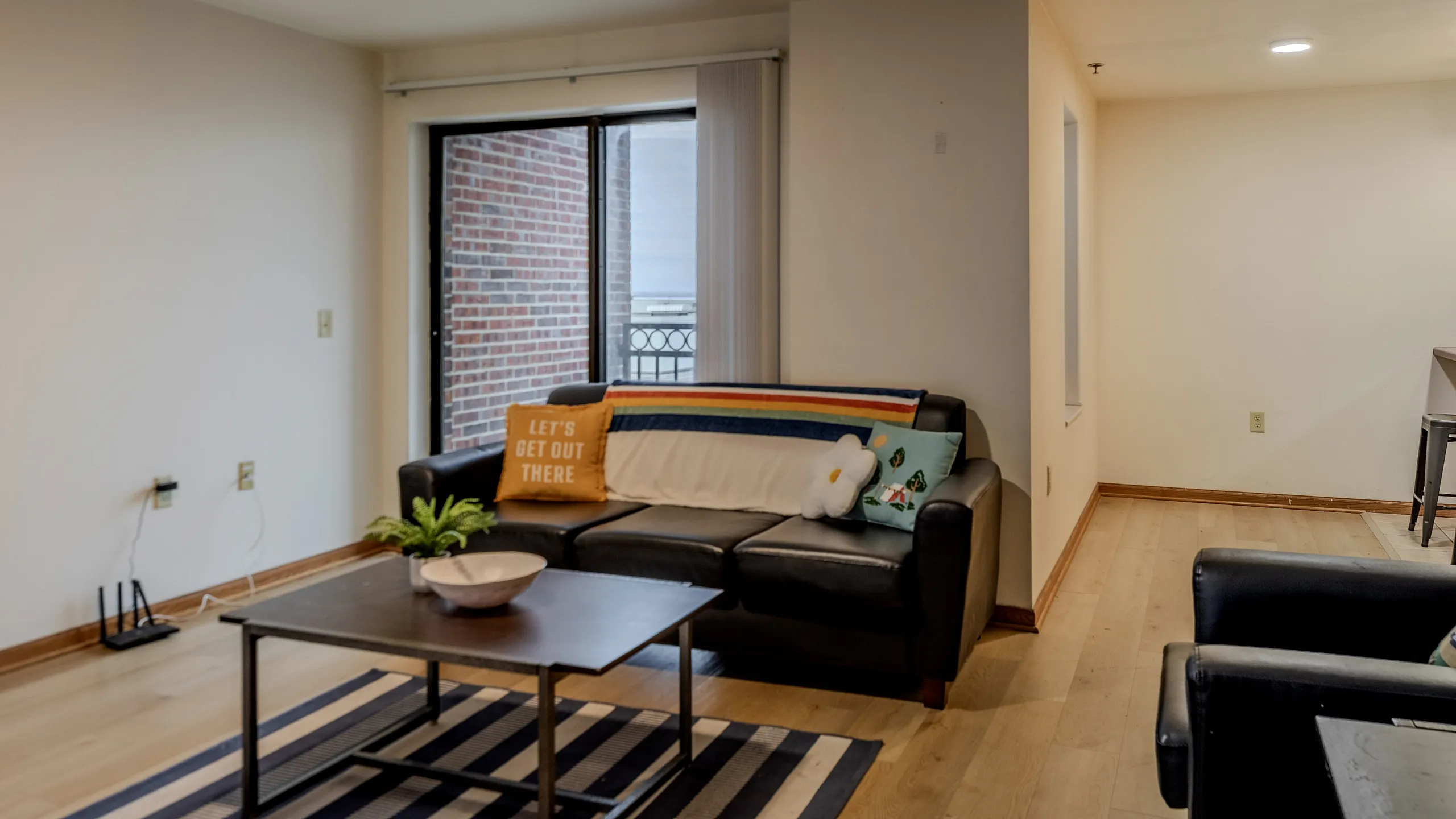 fully furnished apartments with couches, table, breakfast bar and TV