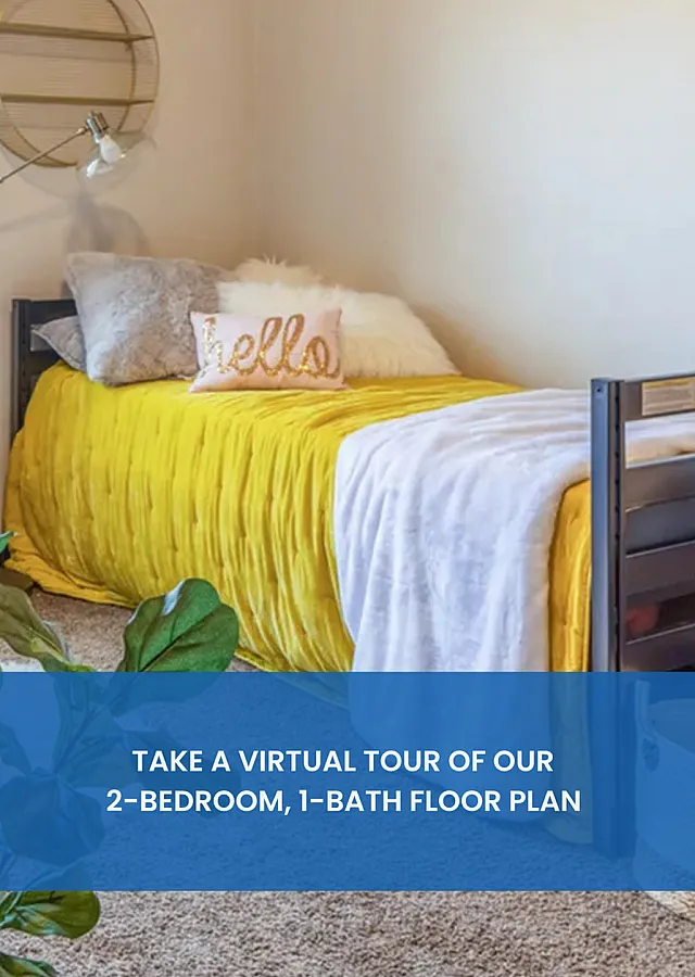 Inviting bedroom scene with a cheerful yellow bedspread, stylish decor, and cozy pillows. Experience our vibrant 2-bedroom, 1-bath floor plan.