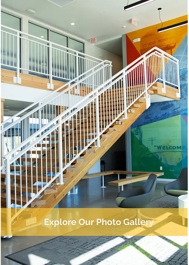 Contemporary apartment lounge with modern staircase, vibrant mural, and stylish seating area inviting exploration.