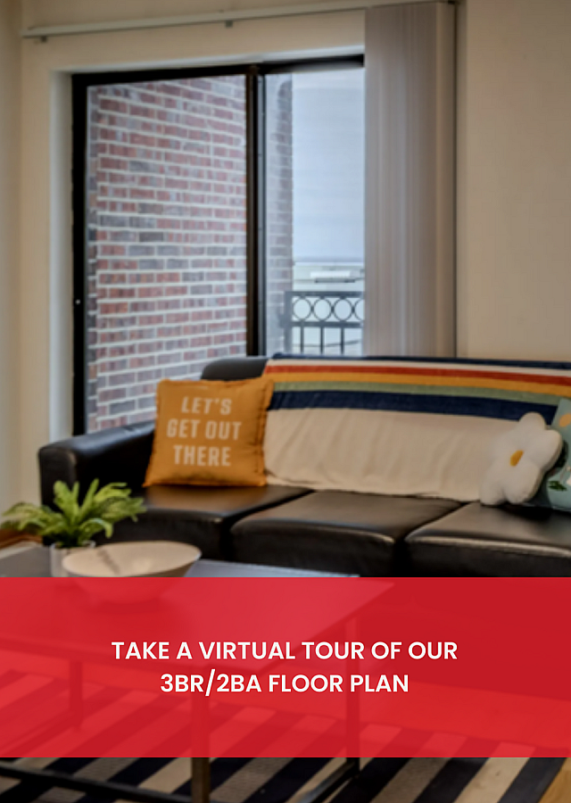 Cozy living room with stylish decor, elegant leather sofa, and large windows overlooking a vibrant cityscape. Ideal 3BR/2BA floor plan for modern living.