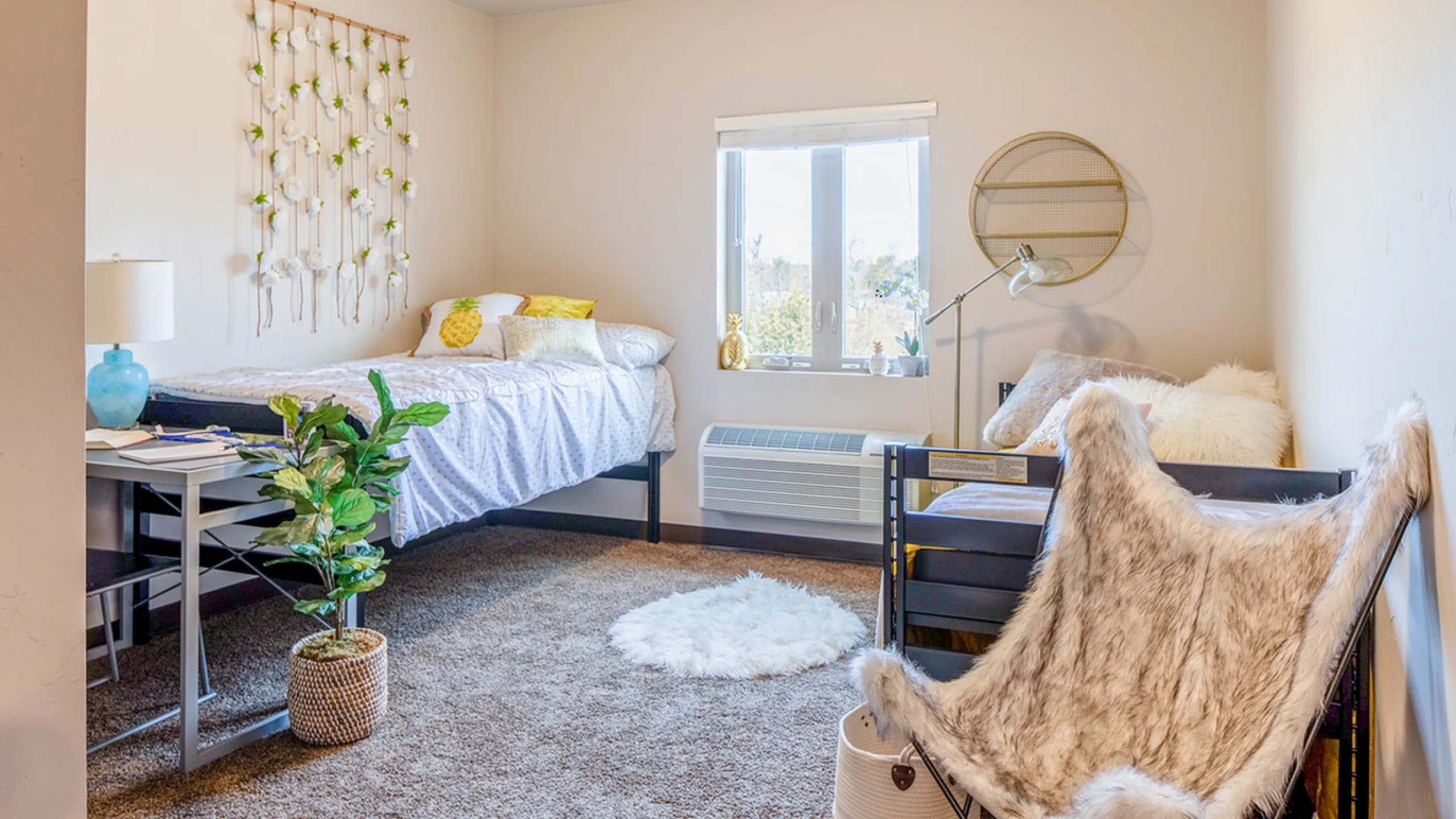 Cozy bedroom with plush furnishings, featuring a bright window, stylish decor, and inviting seating area for relaxation.