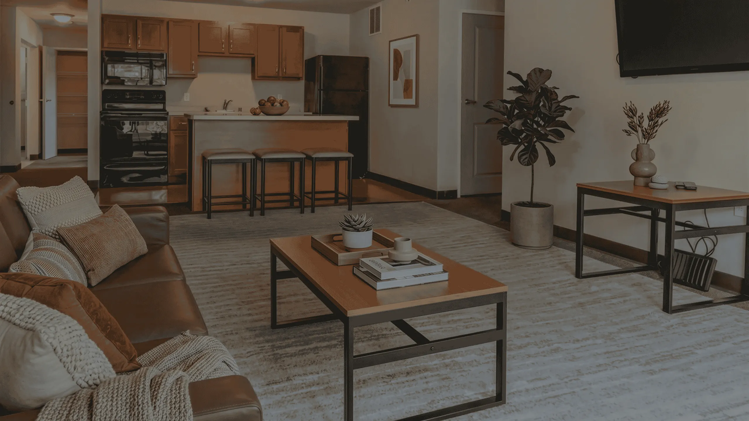 Contemporary living room with cozy seating, elegant decor, and a stylish open kitchen, perfect for modern living.