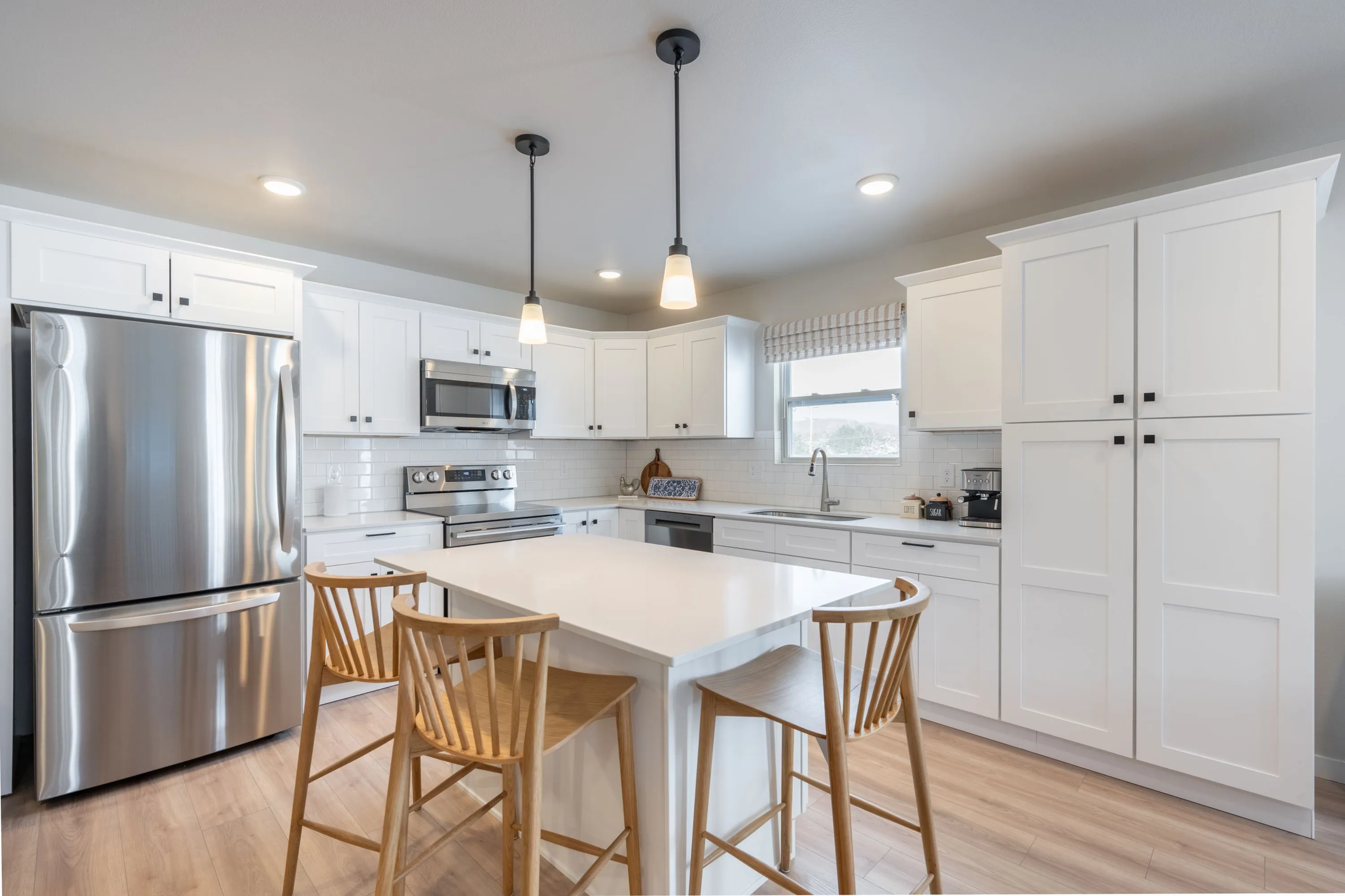 Modern kitchen with sleek white cabinetry and stainless steel appliances