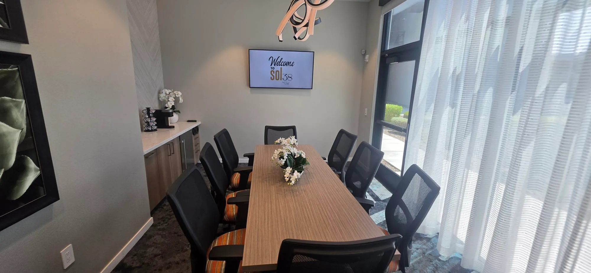 Elegant conference room at Sol38 with a modern table, stylish chairs, and natural light pouring through large windows.
