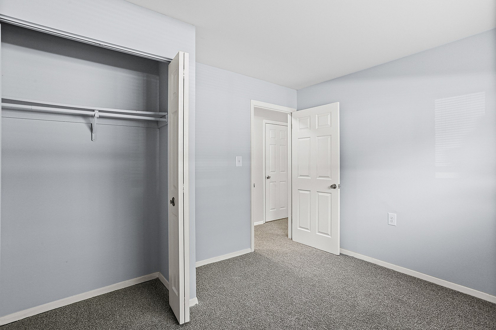 Bright and spacious bedroom with a large closet and fresh modern design, perfect for comfortable living.