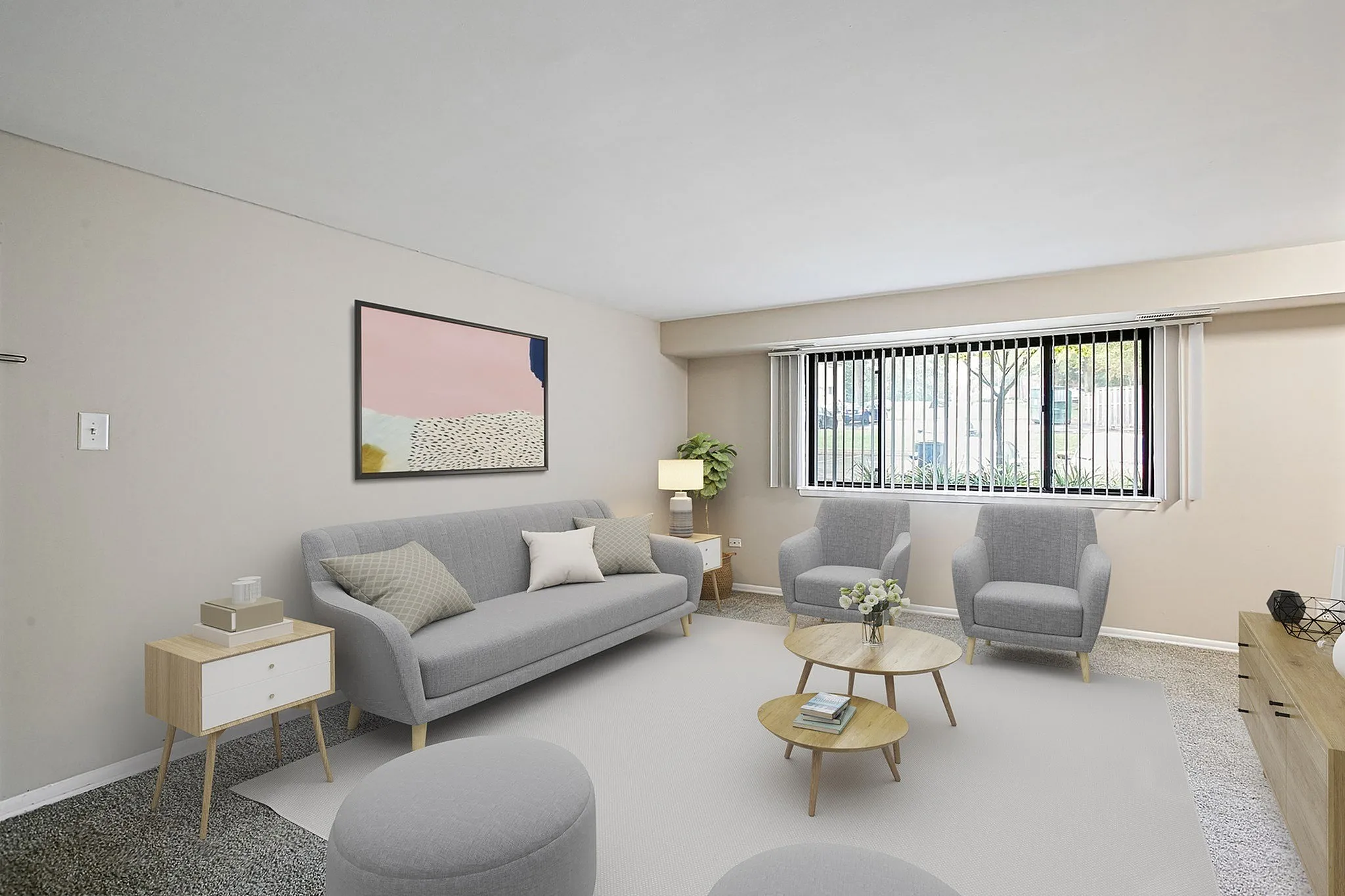 Modern and inviting living room with stylish gray furniture, large window for natural light, and contemporary art piece.