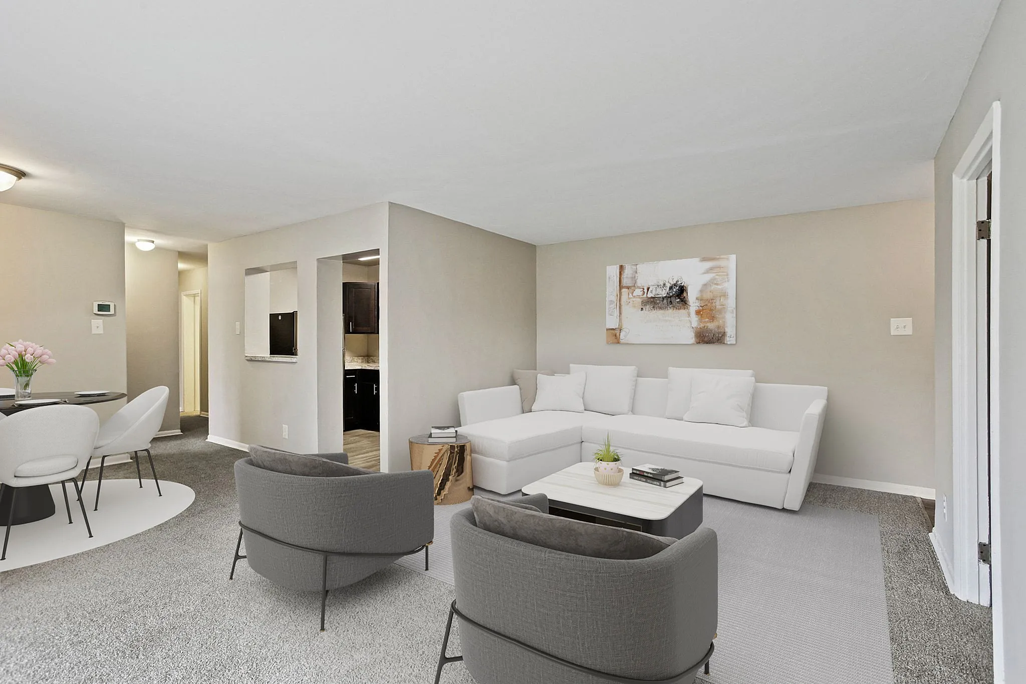 Contemporary open-plan living room with elegant seating, modern decor, and a cozy dining area.