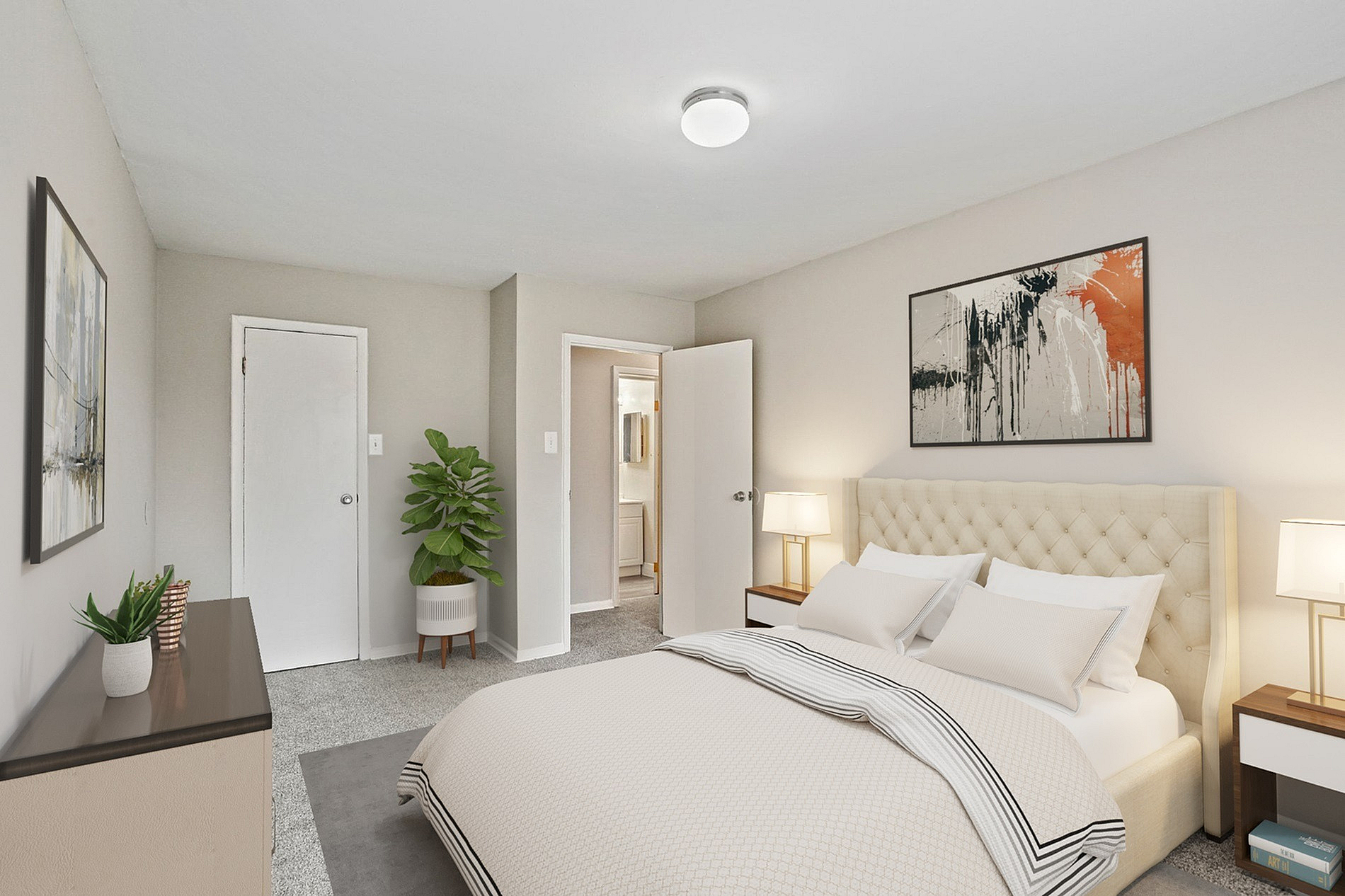 Inviting bedroom with elegant decor, featuring a plush upholstered bed, stylish artwork, and soft neutral tones.