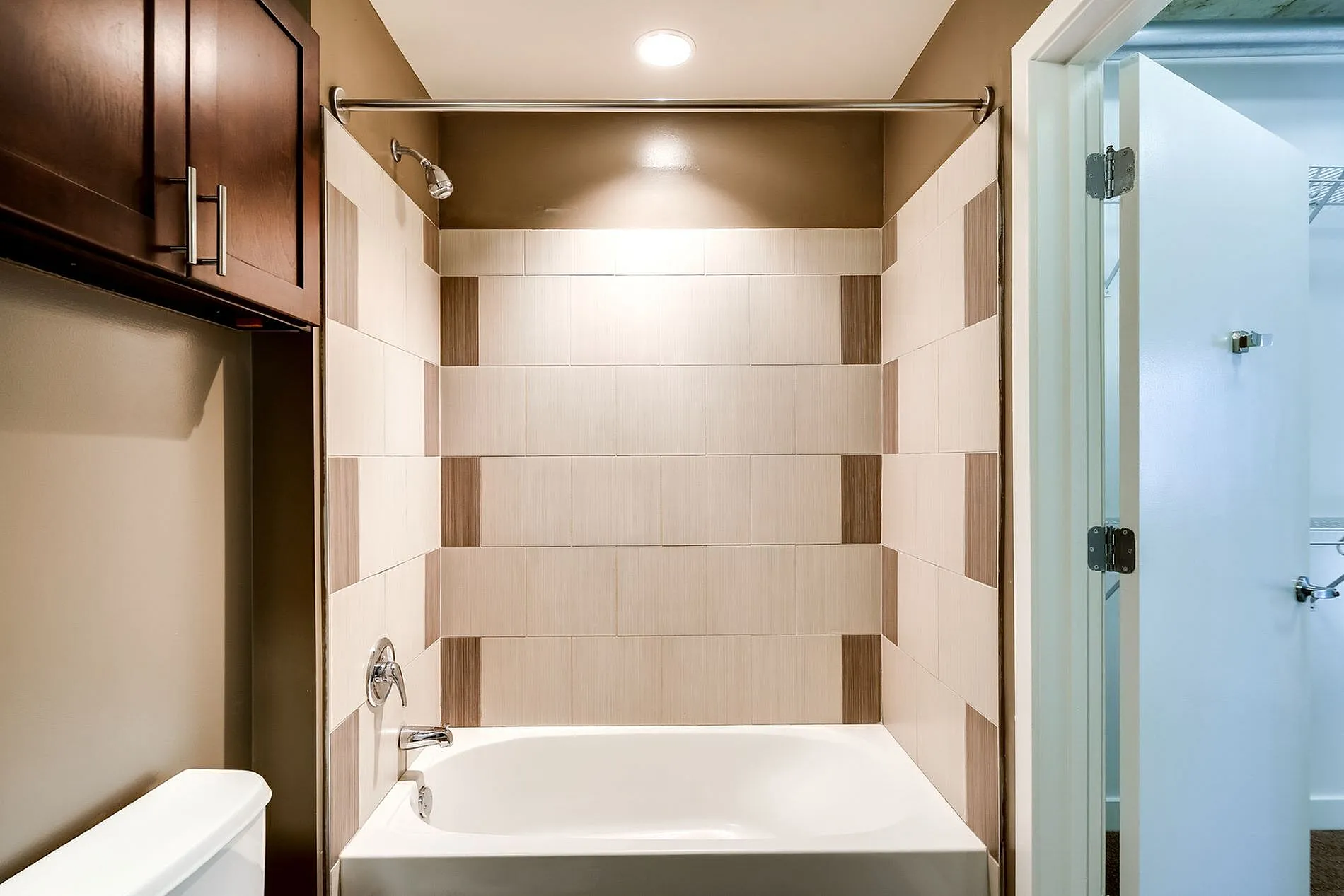 Elegant bathroom with modern tile design and pristine bathtub, offering a luxurious retreat.