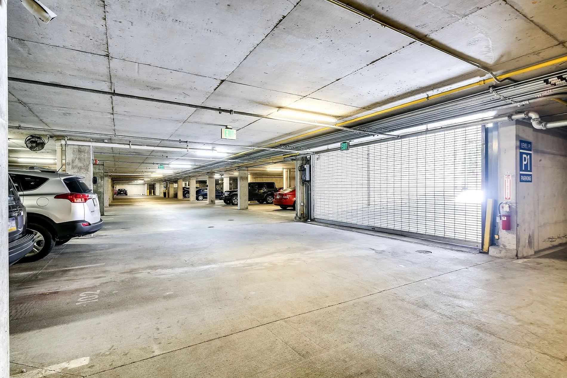 Spacious and well-lit underground parking garage with ample space and secure access.