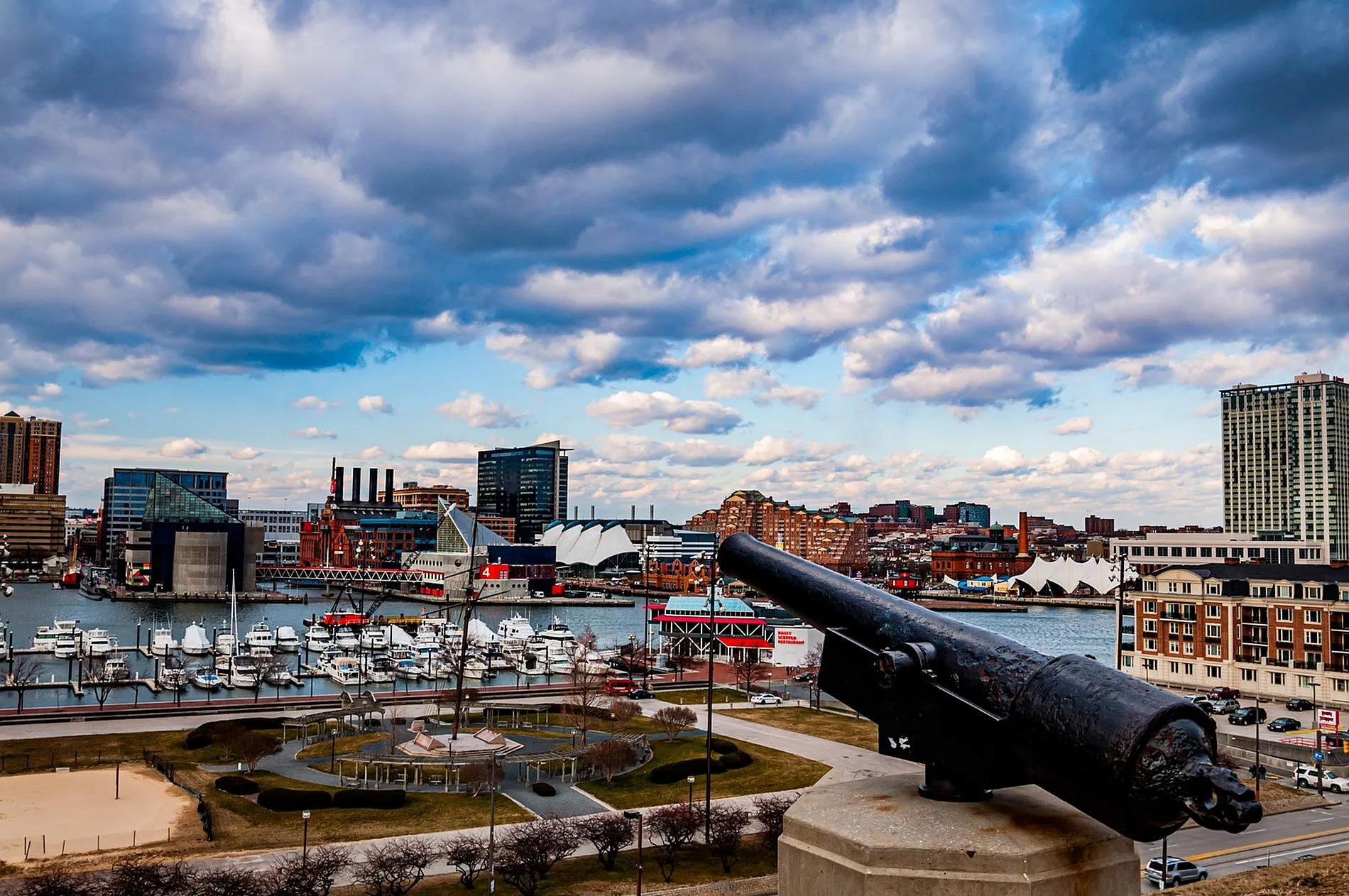Captivating waterfront view with vibrant skyline, historic architecture, and a scenic marina under a dynamic sky.