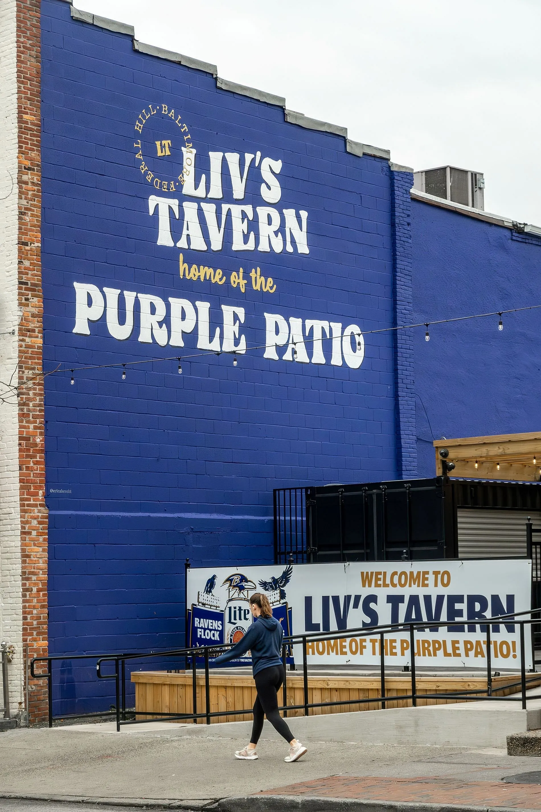 Vibrant exterior of Liv's Tavern with bold purple walls, welcoming visitors to the iconic Purple Patio.