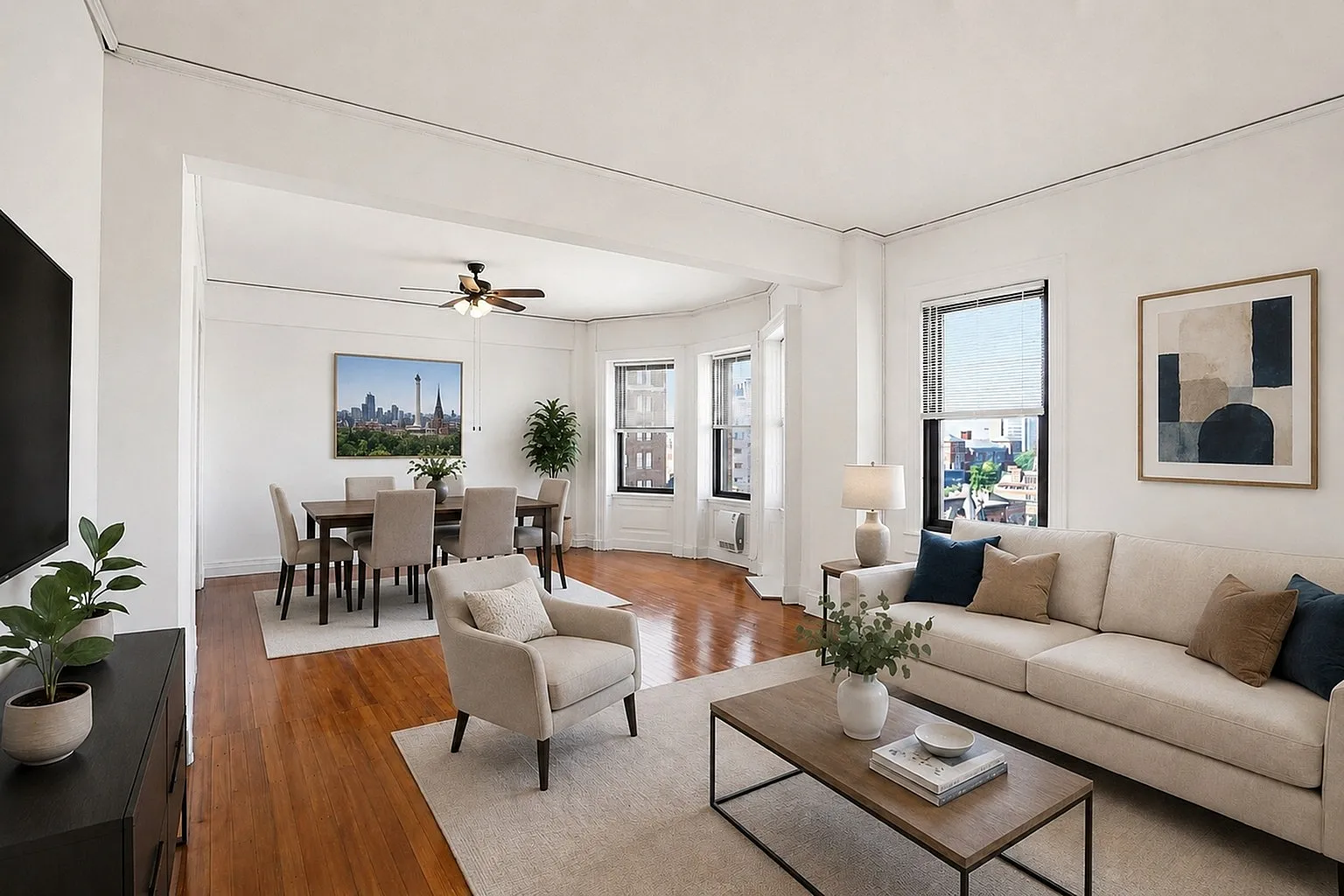 Bright and spacious living and dining area with elegant hardwood floors, large windows offering city views, and modern decor accents.