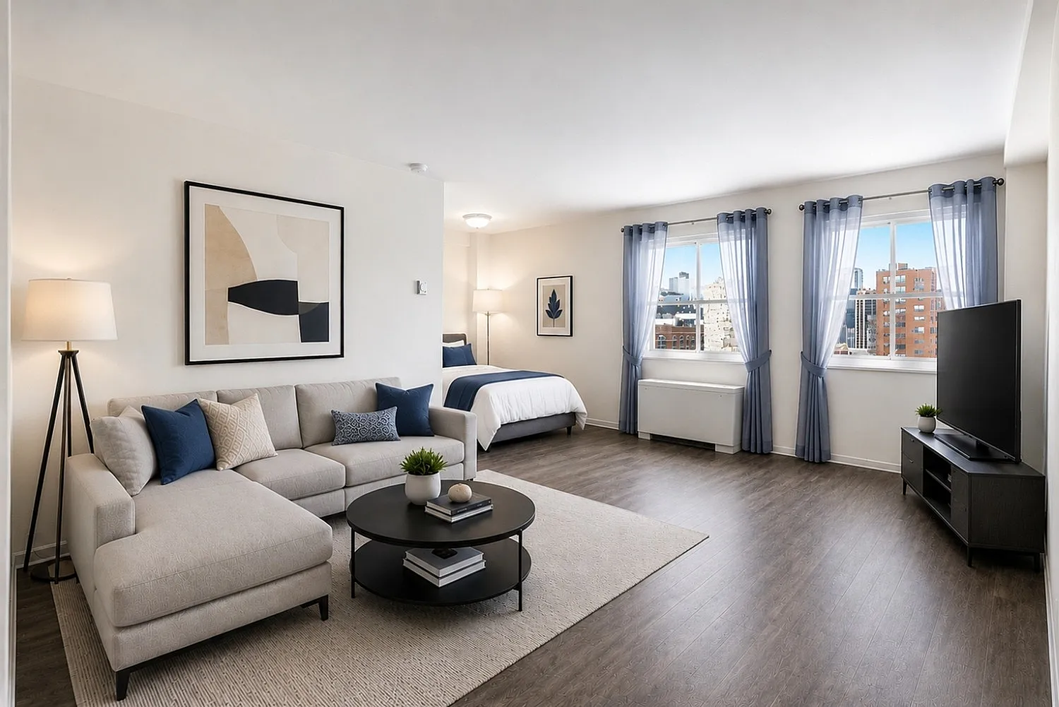 Bright, modern studio apartment with spacious open-plan living area, cozy bedroom nook, stylish décor, and city views.