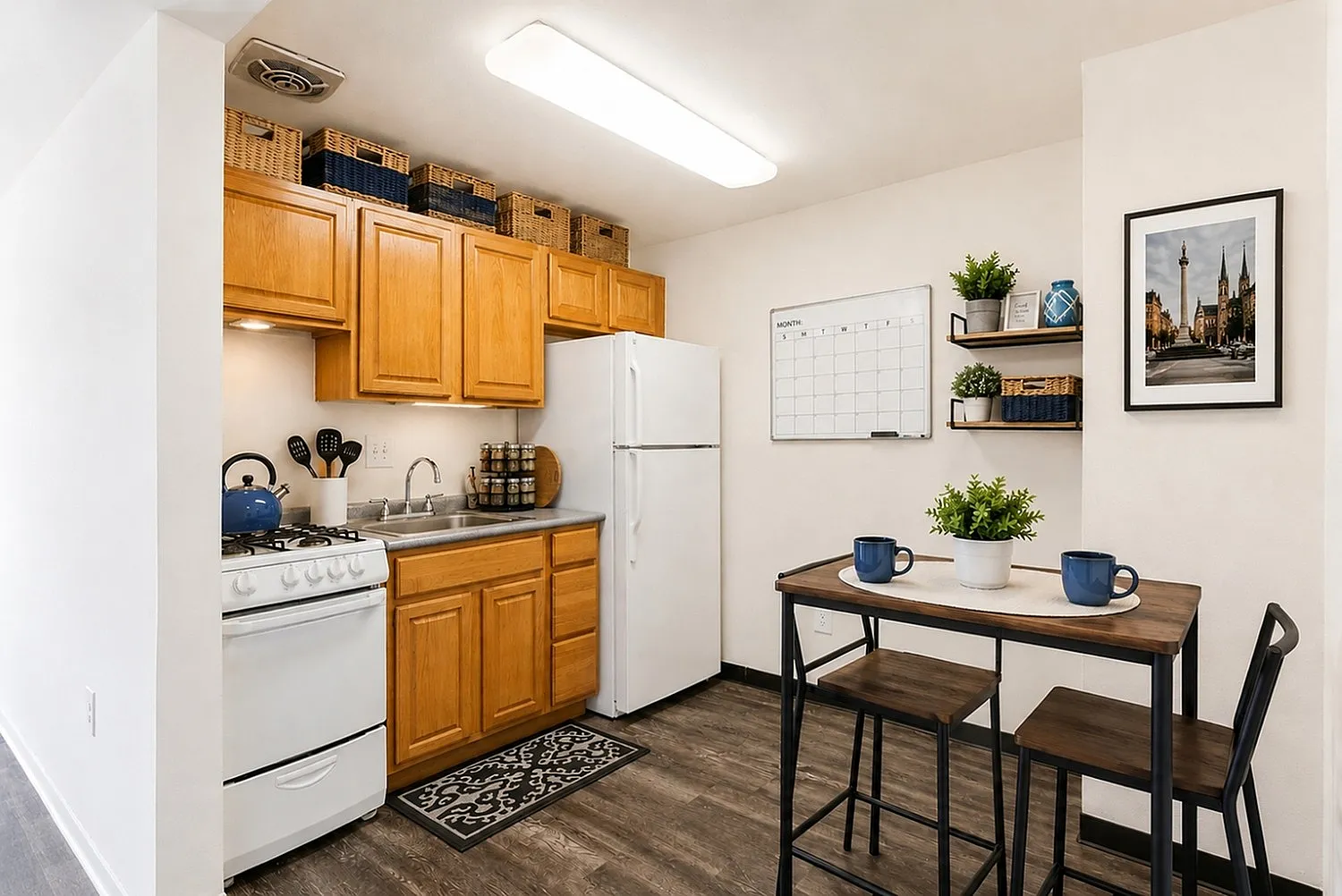 Cozy kitchen with warm wood cabinetry, modern appliances, and stylish dining nook perfect for intimate meals.