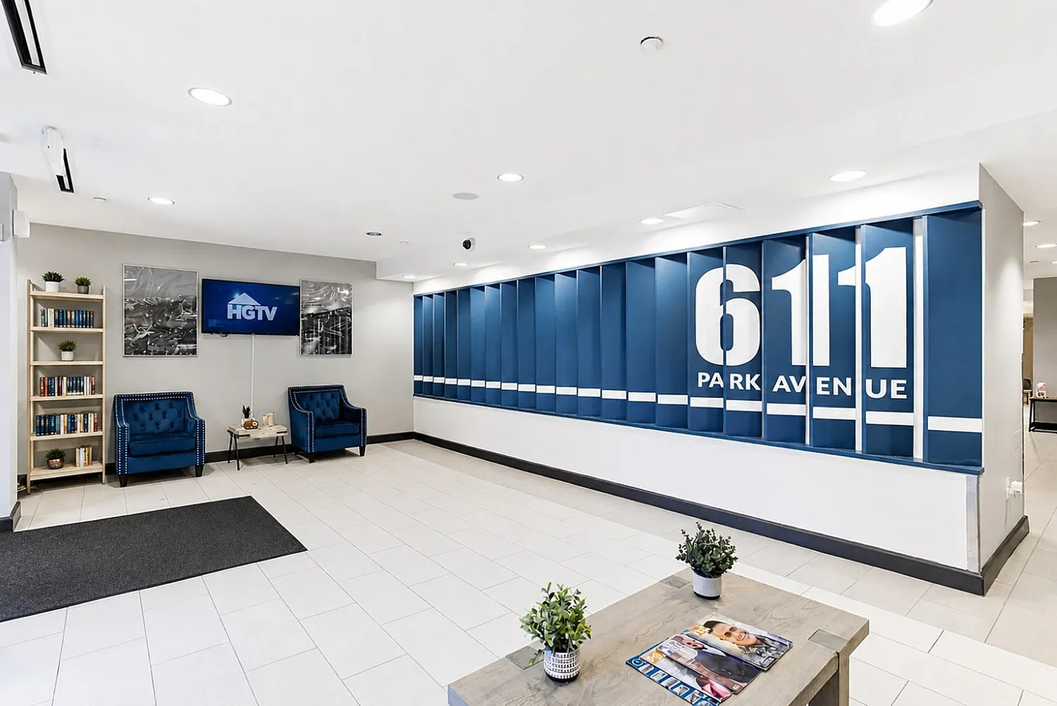 Welcoming lobby at 611 Park Avenue featuring modern decor, cozy seating, and a stylish bookcase.