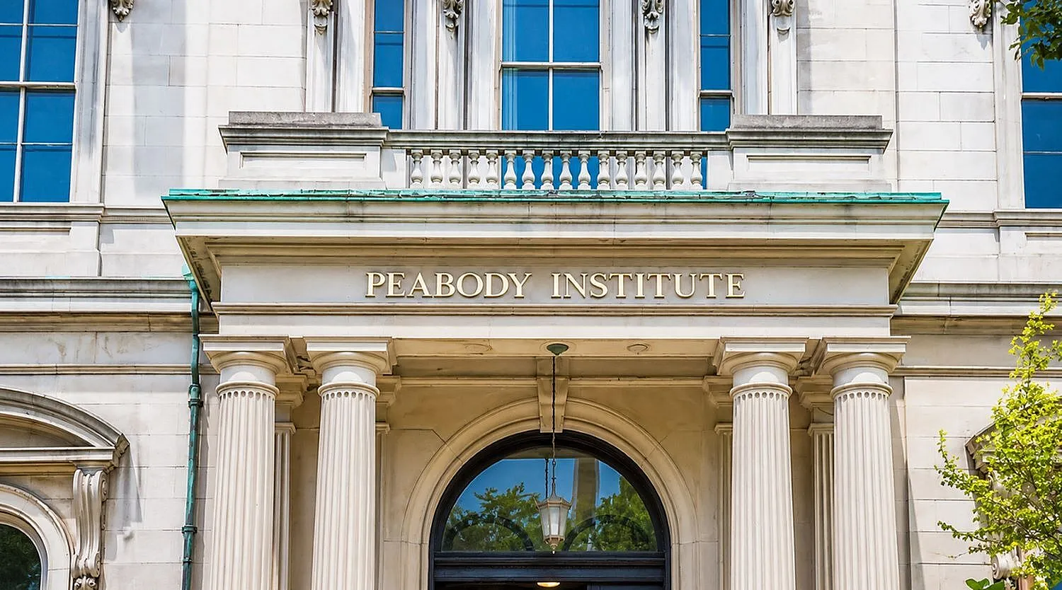 Elegant architectural facade of Peabody Institute with classical columns and intricate detailing.