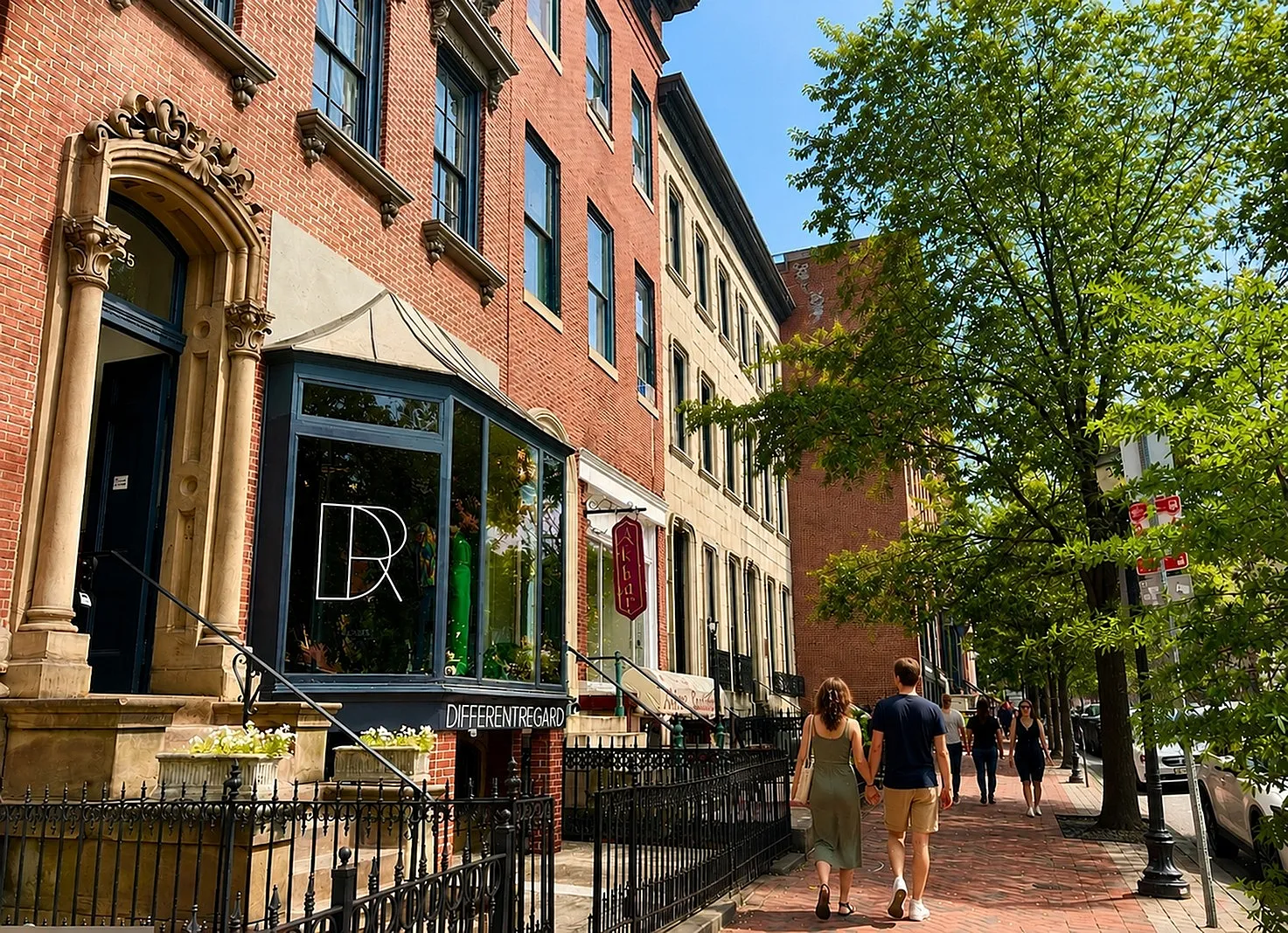 Charming street view of classic row houses with ornate architecture and vibrant storefronts, exuding urban charm and inviting pedestrian appeal.