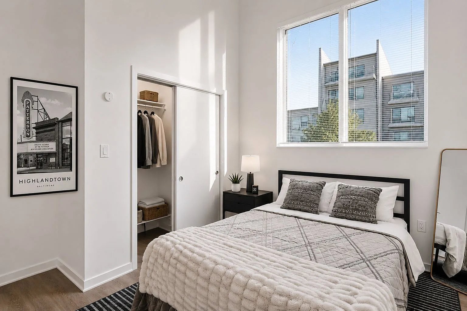 Bright and inviting bedroom with elegant decor, featuring a cozy bed, large window, and ample closet space.