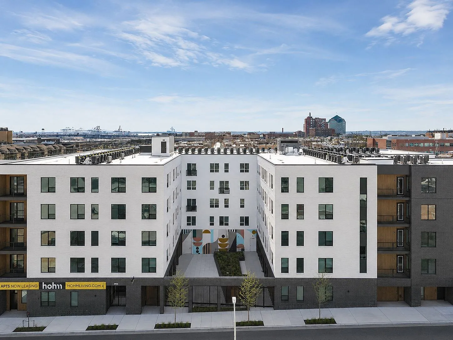 Modern urban apartment complex with sleek design and rooftop views, offering stylish living in a vibrant cityscape.