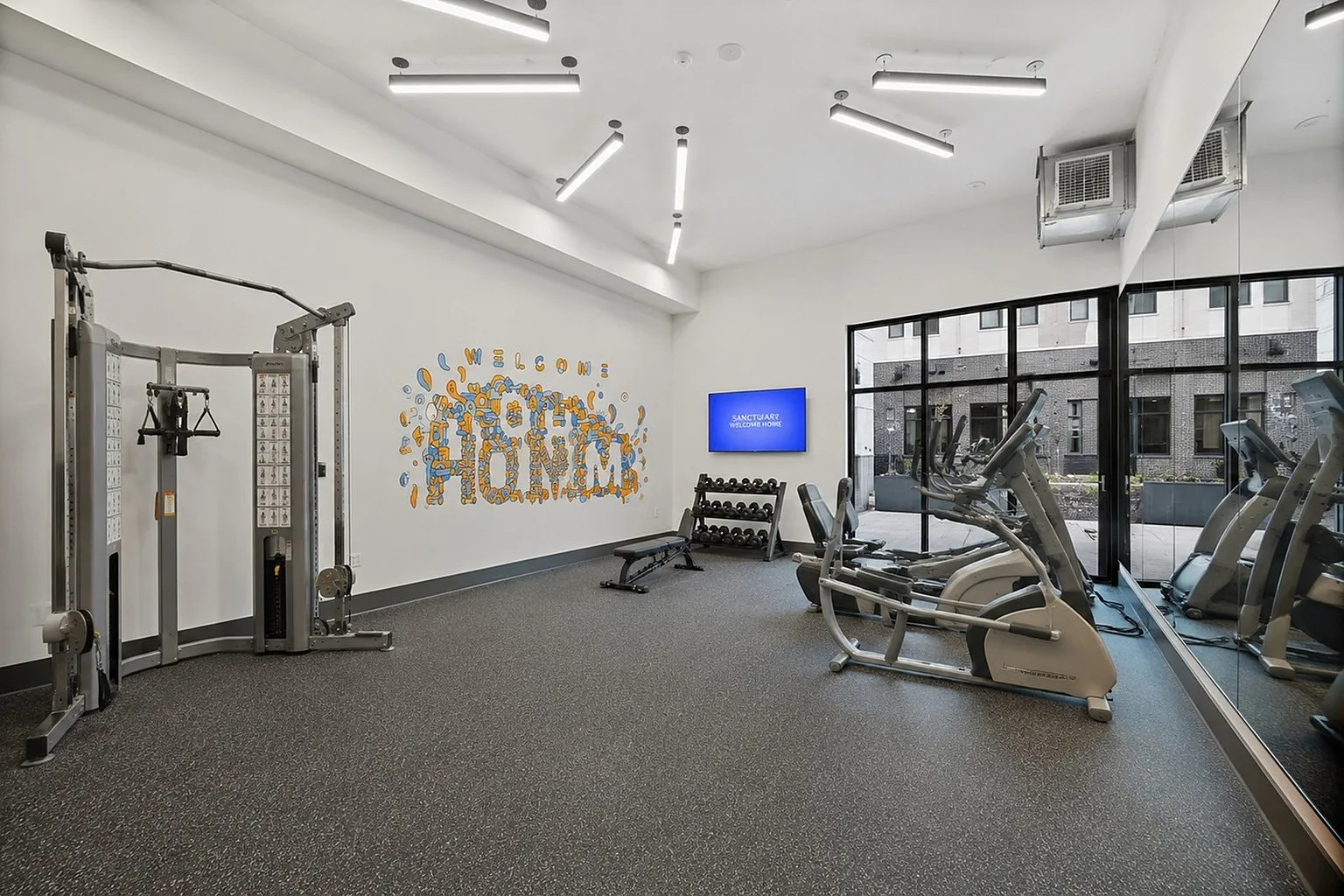 Modern fitness center with state-of-the-art equipment, bright lighting, and welcoming decor, ideal for an energizing workout.